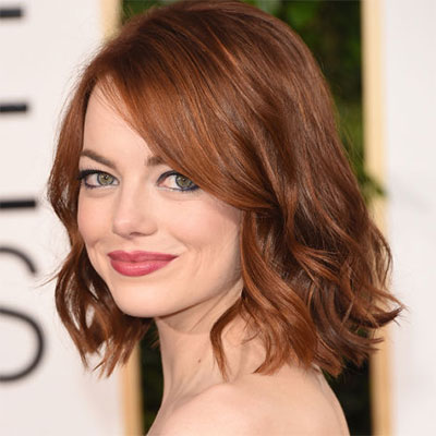 Emma Stone with a light golden brown hair colour with red undertone